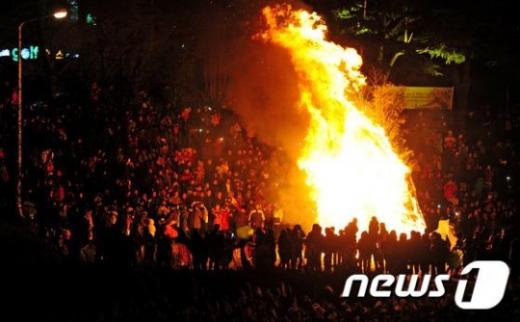 20일 오후 전북 전주시 전주시자원봉사센터 앞 전주천 둔치에서 열린 '정월 대보름 행사'에서 시민들이 타오르는 달집을 바라보고 있다. 사진제공=뉴스1
