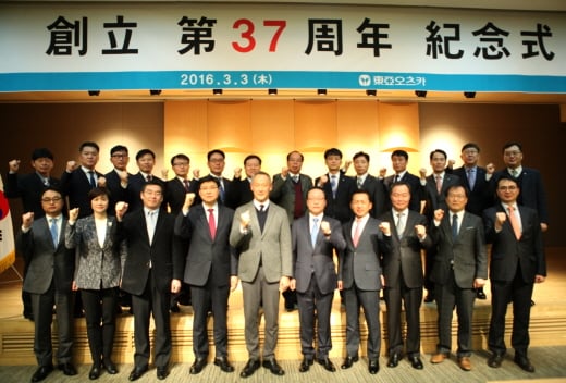 3일 서울 용신동 본사에서 열린 '제37회 창립기념식'에 참석한 동아오츠카 임원 및 장기근속자들이 화이팅 세레모니를 하고 있다. 권도균 경영지원본부 이사, 이진숙 마케팅본부 상무, 와나타베 생산본부장 상무이사, 이기수 감사, 타치바나 대표이사 부사장, 민장성 대표이사 사장, 양동영 영업본부장 상무이사, 배갑용 경영지원본부장 이사, 윤태연 노조위원장, 홍성호 영업본부 이사(앞줄 왼쪽부터). /사진제공=동아오츠카