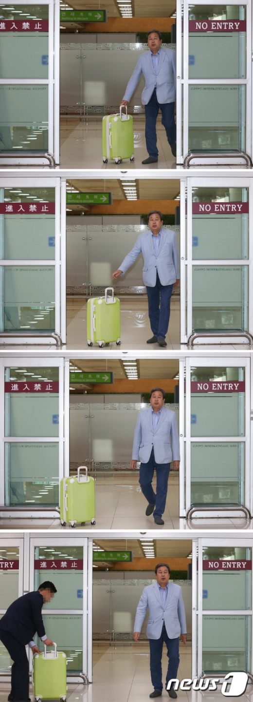 김무성. 노 룩 패스. 김무성 바른정당 의원이 23일 서울 강서구 김포국제공항에서 수행원에게 캐리어를 굴려 보내고 있다. /사진=뉴스1