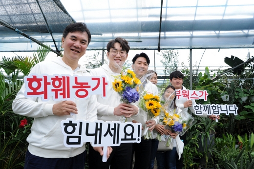 김후식 뷰웍스 대표 및 공채 신입직원들이 서초구에 위치한 화훼단지에 방문해 코로나19로 어려움을 겪고 있는 지역 화훼농가에 응원의 메시지를 전하고 있다./사진=뷰웍스