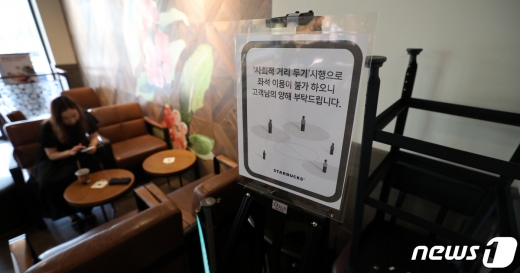 스타벅스가 사회적 거리 두기 2단계 격상에 맞춰 서울과 경기 모든 매장의 좌석을 30% 이상 축소하는 등 방역 수칙을 강화했다. 18일 오후 서울의 한 스타벅스 매장 한켠에 의자와 테이블이 쌓여있다. 2020.8.18/뉴스1 © News1 박지혜 기자