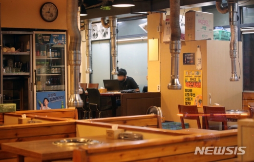 수도권 지역의 사회적 거리두기 2.5단계가 시행된 30일 오후 9시 이후 서울 송파구의 한 음식점의 관계자가 매장 정리를 하고 있다. /사진=뉴시스