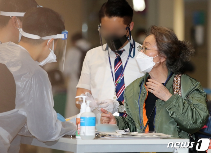 입국 후  인천공항 육군 검역 지원단에게 입국 안내를 받고 있는 윤여정. 2021.5.8/뉴스1 © News1 김진환 기자