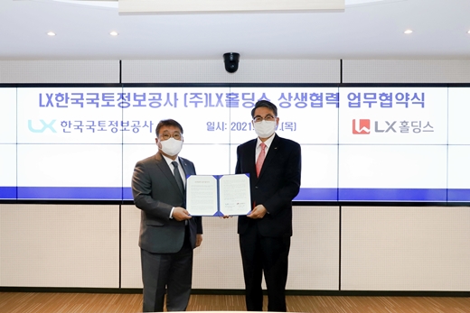 '상생협력을 위한 협약식'에서 협약서에 서명한 후 기념촬영을 하는 김정렬 LX한국국토정보공사 사장(우)과 송치호 LX홀딩스 사장(좌). /사진제공=LX공사