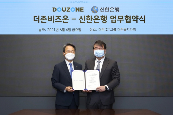 진옥동 신한은행장(왼쪽)과 김용우 더존비즈온 대표가 협약을 맺고 기념촬영을 하는 모습. /사진제공=더존