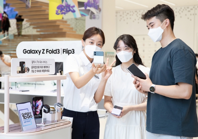 삼성 디지털프라자 홍대점에서 갤럭시 팬큐레이터에게 '갤럭시Z폴드3', '갤럭시Z플립3', '갤럭시워치4' 시리즈를 3일 간 자유롭게 체험해볼 수 있는 '갤럭시 To Go 서비스'를 안내받고 있는 모습. /사진제공=삼성전자