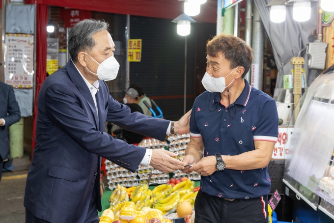 새마을금고중앙회는 17일 추석을 앞두고 전통시장 내 보안과 안전망을 구축하는 범죄예방환경설계(CPTED) 조성사업에 5000만원을 지원한다고 밝혔다. 사진은 박차훈 새마을금고중앙회장이 울산신정시장에서 과일을 구매하며 상인과 담소를 나누고 있는 모습./사진=새마을금고중앙회