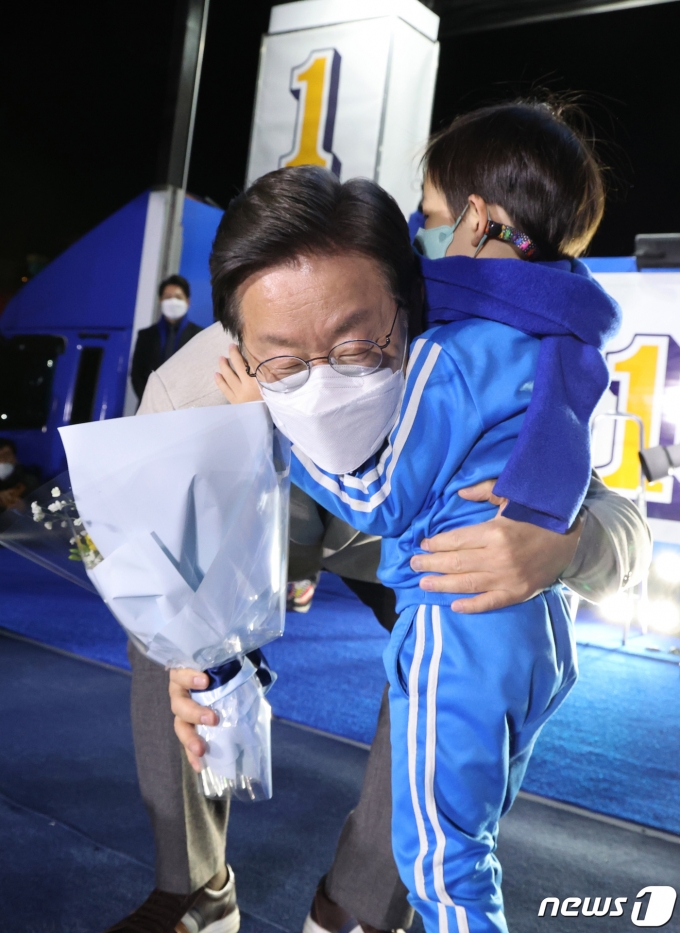 이재명 더불어민주당 대선 후보가 28일 저녁 경북 안동시 웅부공원에서 열린 '안동의 아들 이재명, 대통령으로 키웁시다' 안동 유세에서 어린이에게 꽃다발을 받고 있다. 2022.2.28/뉴스1 © News1 이동해 기자