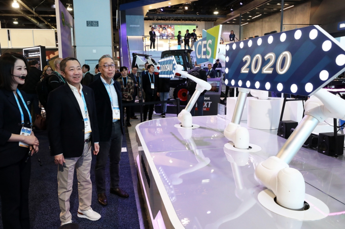 지난 2020년 국제가전전시회 'CES 2020'(Consumer Electronics Show) 두산 전시장에서 박정원 두산그룹 회장(가운데)과 박지원 두산중공업 회장이 두산로보틱스 협동로봇의 사인 스피닝(Sign Spinning) 퍼포먼스를 지켜보는 모습./사진=뉴스1
