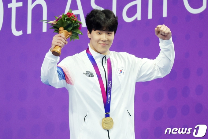 25일 오후 중국 항저우 올림픽 스포츠센터 수영장에서 열린 남자 자유형 50ｍ 결승전에서 1위를 차지한 대한민국 지유찬이 금메달을 목에 걸고 기뻐하고 있다. 2023.9.25/뉴스1 ⓒ News1 민경석 기자