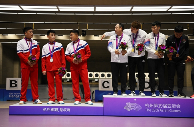 10m 러닝타깃 단체전 시상식에서 2위 북한 선수들이 1위 한국 선수와의 사진 촬영을 거부했다. 사진은 10m 러닝타깃 단체전 시상식에서 한국들을 외면하는 북한 선수들의 모습. /사진=로이터