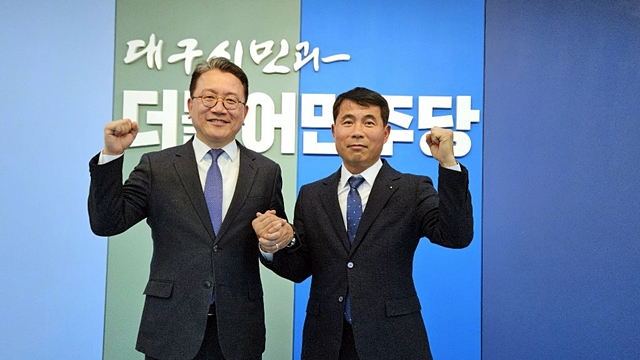 강민구 민주당 대구시당 위원장(왼쪽)과 수성구의원 재보궐선거 후보자 전학익 씨(오른쪽)가 손을 맞잡고 선거에서 선전을 다짐하고 있다./사진제공=더불어민주당 대구광역시당