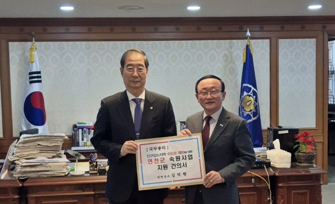 김덕현 연천군수가 한덕수 국무총리(왼쪽)에게 연천군 숙원사업 지원 건의서를 전달하고 있다.  /사진제공=연천군