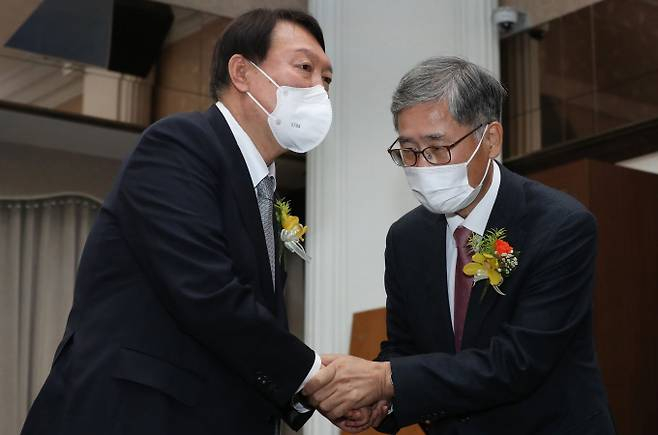 윤석열 대통령이 국민의힘 대선 후보 시절이던 2021년 11월 9일 서울 중구 한국프레스센터에서 열린 신평 변호사의 출판기념회에 참석해 신 변호사와 악수하고 있다./사진제공=뉴스1