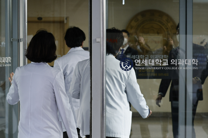 전국 의대 교수들이 의대생 유급과 전공의 면허정지 처분에 반발해 오는 25일부터 사직서를 일괄 제출하기로 한 가운데 연세대도 동참하기로 결정했다. 지난 18일 오후 의료진들이 서울 서대문구 연세대학교 의과대학에 들어가고 있다. /사진=뉴스1