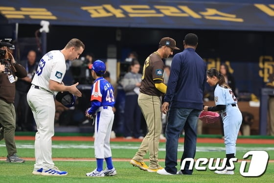 21일 서울 구로구 고척스카이돔에서 열린 2024 미국 메이저리그(MLB) 월드투어 서울시리즈 공식 개막전 샌디에이고 파드리스와 LA 다저스의 2차전이 열렷다. 경기에 앞서 리틀야구 선수 백지수 양(오른쪽)과 김재아 군(왼쪽에서 두 번째)이 시구를 마친 뒤 메이저리거들과 인사를 나누고 있다. 2024.3.21/뉴스1 김진환 기자