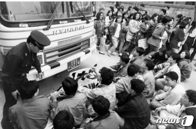1992년 4월 4일  청주지법 충주지원이 김보은 징역 5년, 김진관 징역 7년형을 내리자 동료 학생들이 '그들은 죄가 없다'며 호송차를 가로막고 연좌농성을 펼치고 있다. (한겨레 갈무리) ⓒ 뉴스1