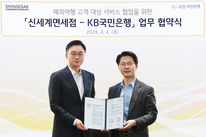 4일 서울시 영등포구 소재 KB국민은행 신관에서 열린 '해외여행 고객 대상 서비스 협업을 위한 신세계면세점-KB국민은행 업무 협약식'에서 양호진 신세계디에프 전무(좌측)와 박병곤 KB국민은행 기업고객그룹 부행장(우측)이 기념 사진을 촬영하고 있다./사진=KB국민은행  