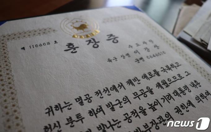 국군포로 고(故) 이강산 씨가 정부로부터 수여 받은 '무성화랑 무공훈장' 훈장증. 이 씨는 조국을 구하기 위해 '빛나는 공적'을 세웠지만 조국 대한민국은 그와 그의 후손 누구도 하나 구하지 않았다. 2024.3.21/뉴스1 ⓒ News1 박동해 기자