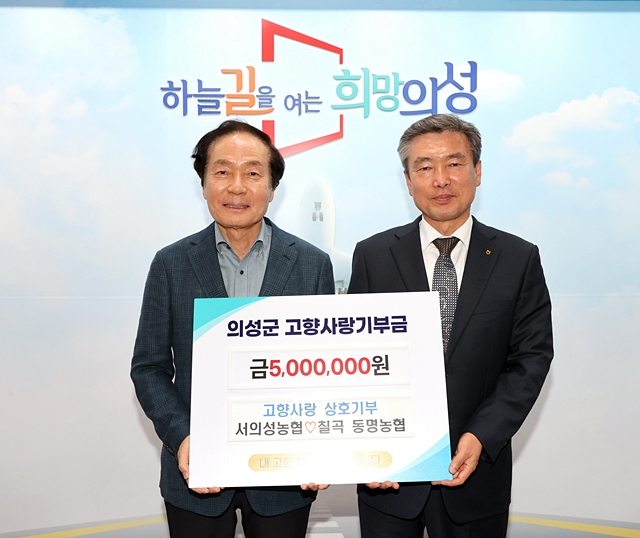 최병천 동명농협 조합장(오른쪽)이 김주수 의성군수(왼쪽)에게 고향사랑기부금 500만 원을 전달하고 있다./사진제공=경북 칠곡동명농업협동조합