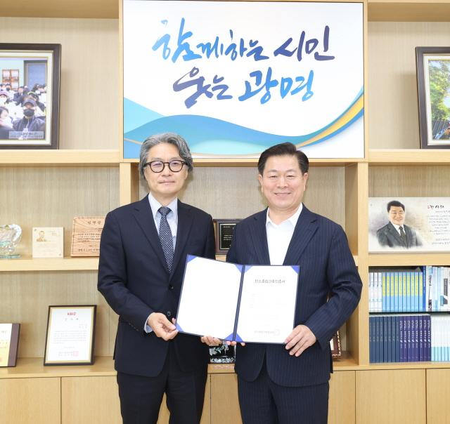 박승원 광명시장(오른쪽)이 광명시가 태성호 탄소중립스마트건축센터장으로부터 건물부문 탄소중립건축인증 등급을 처음으로 취득한 뒤 포즈를 취하고 있다. / 사진제공=광명시