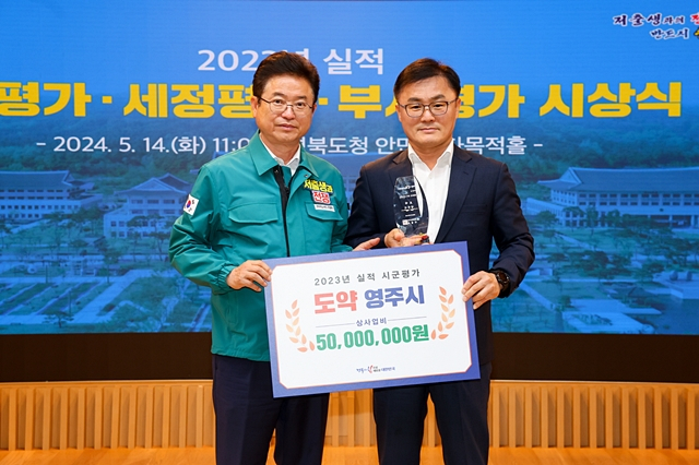 이철우 경북도지사(왼쪽)가 영주시 관계자에게 도정 역점시책 시·군 종합평가 우수상을 수여하고 있다./사진제공=경북 영주시