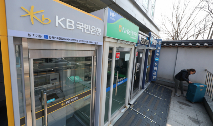 서울 시내에 설치된 시중은행 ATM 기기 앞을 한 시민이 지나고 있다./사진=뉴스1