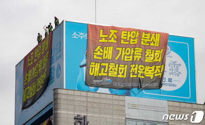 전국민주노동조합총연맹(민주노총) 공공운수노조 화물연대 조합원들 24일 오전 서울 강남구 하이트진로 본사 옥상에서 고공 농성을 하고 있다. 2022.8.24/뉴스1 ⓒ News1 이재명 기자