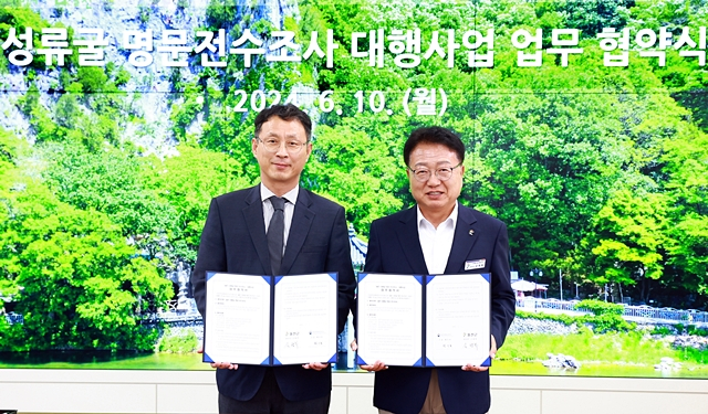 손병복 울진군수(오른쪽)와 황인호 국립경주문화유산연구소장이 10일 성류굴 명문 전수조사를 위한 업무협약을 한 뒤 포즈를 취하고 있다. /사진제공=경부 울진군