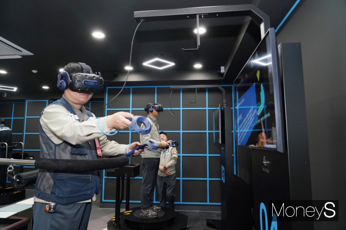LG화학 임직원이 VR시뮬레이터를 통해 화학공장설비 염산누출 가상체험을 하고 있다/사진=LG화학 여수공장 제공.