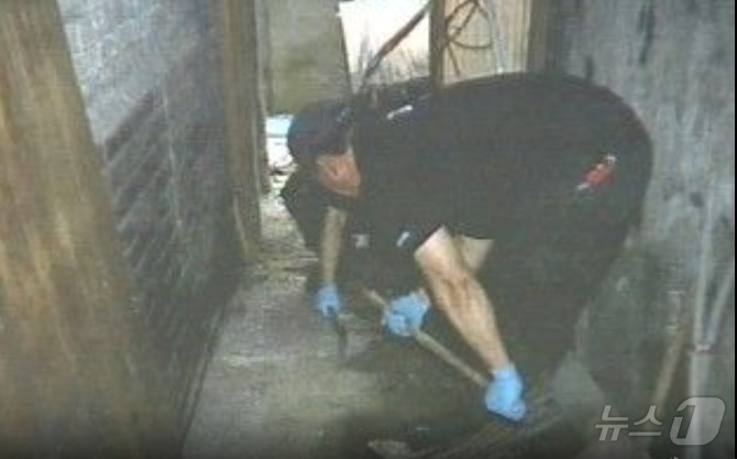 경찰이 A 목사 집 담벼락 밑을 파헤치고 있다. A 목사는 2009년 3월 5일 자정 무렵 아내를 살해한  A 목사는 3월 22일 시신을 토막낸 뒤 그 일부를 자신의 집 담장밑에 파 묻었다. (SBS 갈무리)