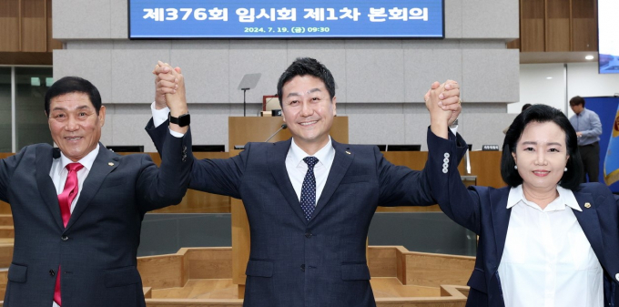 제11대 경기도의회 후반기 의장에 선출된 김진경(가운데) 신임 의장이 신임 부의장들과 시의원들에게 손을 들어 인사하고 있다. 사진제공=경기도의회 