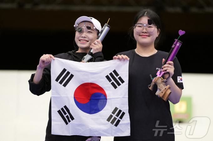 사격 금메달을 획득한 오예진(오른쪽)과 김예지가 태극기를 들고 기뻐하고 있다. ⓒ 로이터=뉴스1