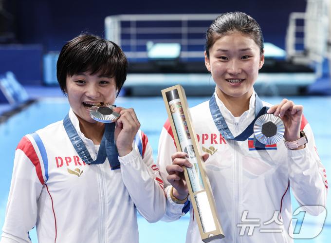 북한 조진미와 김미래 선수가 31일 오후(한국시간) 프랑스 생드니 아쿠아틱스 센터에서 열린 2024 파리올림픽 다이빙 여자 싱크로나이즈드 10M 플랫폼 시상식에서 수여 받은 은메달을 들고 포즈를 취하고 있다. 2024.7.31/뉴스1 ⓒ News1 박정호 기자