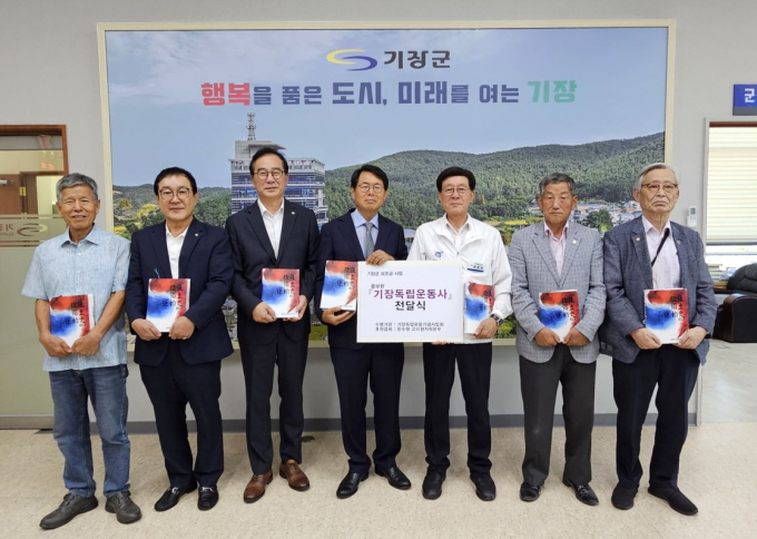 정종복 기장군수(오른쪽 세 번째)와 이광훈 고리본부장(왼쪽 세 번째), 김경호 기장독립운동기념사업회장(가운데), 공태도 기장향토사학자(오른쪽 첫 번째) 등 관계자들이 기장독립운동사 증보판 전달식을 가진 뒤 기념촬영을 하고 있다./사진=기장군