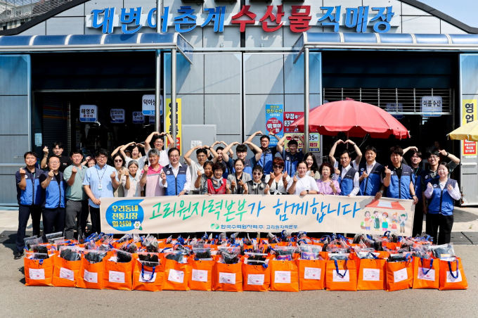 고리원자력본부 관계자들이 5일 대변 수산물직매장에서 장보기 행사를 진행하고 기념촬영을 하고있다./사진=고리본부