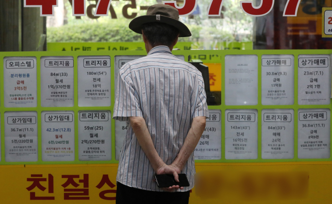 정부가 폭증하는 가계부채를 관리하기 위해 주택구입 정책대출의 금리를 높인다. 사진은 지난 11일 서울 송파구 부동산중개업소 앞에서 한 시민이 매물 정보를 바라보고 있는 모습. /사진=뉴스1