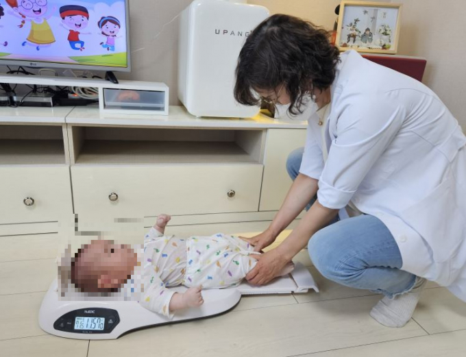 전문 의료인이 '찾아가는 맘스톡톡' 서비스 신청자 집에 방문해 신생아의 건강을 확인중이다 / 사진제공=오산시