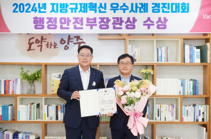 강수현 양주시장(왼쪽)이 '2024년 지방규제혁신 우수사례' 경진대회에서 행정안전부장관상을 수상한 기획예산과 이송주 과장과 기념촬영하고 있다. / 사진제공=양주시
