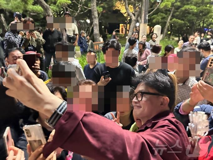 한동훈 국민의힘 대표가 5일 밤 부산 해운대해수욕장을 찾아 시민들과 만나 사진 촬영을 하고 있다. (독자 사진 제공)