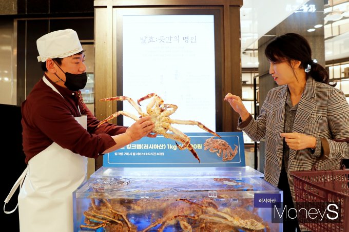 광주신세계 본관 지하 1층 수산코너에서 레드 킹크랩을 고객이 살펴보고 있다/사진=광주신세계 제공.
