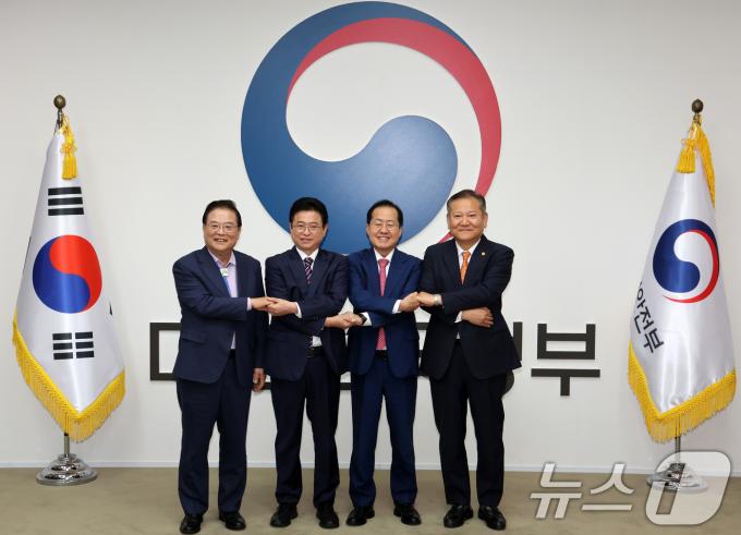 우동기 지방시대위원장(왼쪽부터), 이철우 경북도지사, 홍준표 대구시장, 이상민 행정안전부 장관이 21일 오후 서울 종로구 정부서울청사에서 열린 대구·경북 통합 관련 4자 회동에서 합의문에 서명한 뒤 기념촬영을 하고 있다. (공동취재) 2024.10.21/뉴스1 ⓒ News1 허경 기자