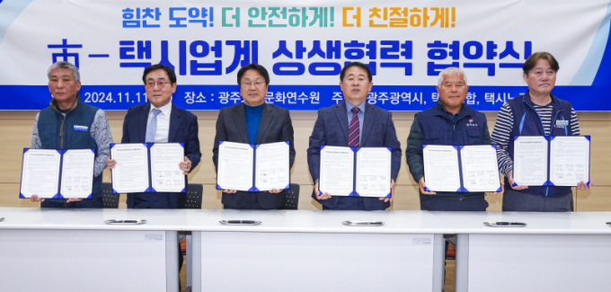 강기정 광주광역시장(왼쪽 세번째)이 11일 북구 광주교통문화연수원에서 열린 택시운송사업 안정화 및 상호 신뢰구축을 위한 ‘시-택시업계 상생협약’을 체결한 뒤 단체 기념촬영을 하고 있다./사진=광주시