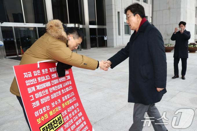 김상욱 국민의힘 의원이 13일 오전 서울 여의도 국회 본청 앞에서 윤석열 대통령 탄핵 찬성 호소 1인 시위 중 만난 권성동 원내대표와 인사하고 있다. 2024.12.13/뉴스1 ⓒ News1 김민지 기자
