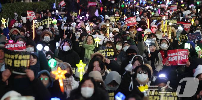 서울 영등포구 여의도 국회 앞에서 열린 '윤석열 즉각 탄핵 구속 촉구 촛불문화제'에서 참가자들이 응원봉과 손피켓을 들어 보이고 있다. 2024.12.13/뉴스1 ⓒ News1 김진환 기자