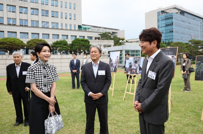 윤석열 대통령 부인 김건희 여사가 박찬욱 감독에게 자신을 주인공으로 한 영화를 찍으면 어떻겠냐고 제안했었다는 의혹이 제기됐다. 김 여사가 2022년 6월12일 서울 용산 대통령실 잔디광장에서 열린 칸 영화제 수상기념 영화 관계자 초청 리셉션 및 만찬에서 배우 송강호, 박찬욱 감독과 대화하고 있다. /사진=대통령실