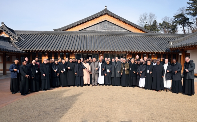 김재욱 칠곡군수(가운데)가 성 베네딕도회 오틸리엔 연합회 수도자들과 함께 향사아트센터에서‘럭키 칠곡’ 포즈로 기념 촬영을 하고 있다./사진제공=경북 칠곡군