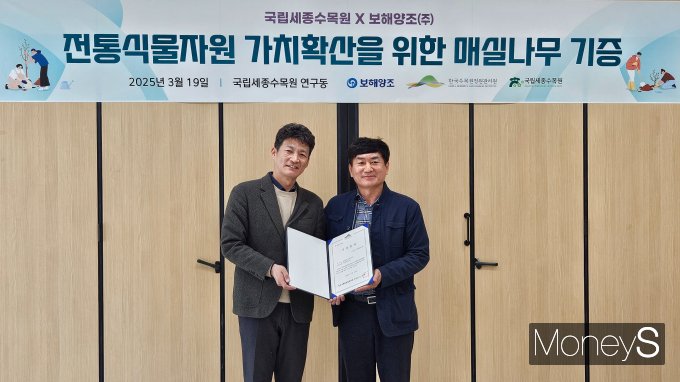 최현준 보해양조 센터장(오른쪽)과 신창호 국립세종수목원 원장이 전통식물자원 가치확산을 위한 매실나무 기증식을 갖고 있다/사진=보해양조 제공.