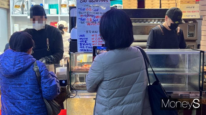 지난해 말부터 지하철역 내에 위치한 '1달러 피자'가 유행하고 있다. 사진은 잠실역에 있는 1달러 피자가게에 줄 선 사람들의 모습. /사진=김민서 기자