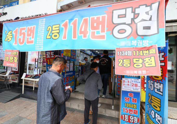  서울 시내 한 복권 판매점 모습.   기획재정부가 국회에 제출한 국정감사 자료집에 따르면 올해 상반기 복권 판매액은 총 3조 6168억원으로 작년 상반기(3조 3790억원)보다 7% 늘었다. 하반기에도 상반기만큼 복권을 판매하게 된다면 연간 판매액이 7조원을 넘을 전망이다. 2024.10.14. hwang@newsis.com /사진=황준선